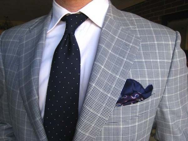 Black tie with white polka dots